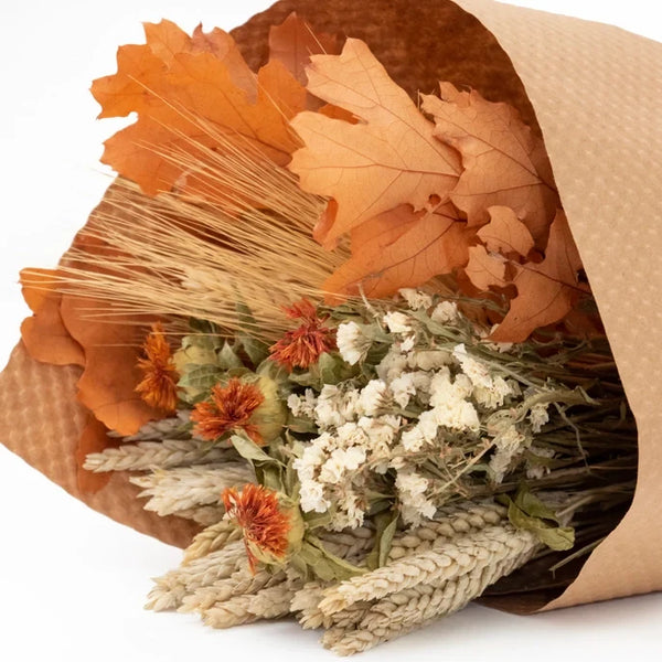 Fll dried floral bouquet of natural grains. cardamom. larkspur nd oakleaves wrpped in texture brown craft paper, 25in.L