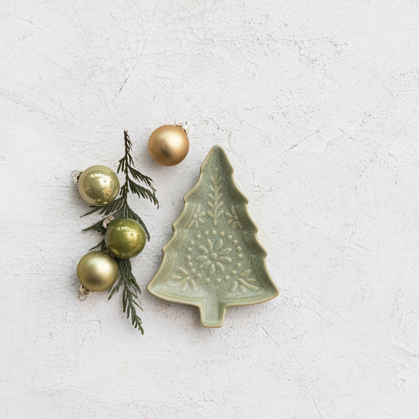 GreenStonewareTreeShapedPlatewithEmbossedDesign displayed with anarbovitae sprig and small metallic ornaments in grren and gold tones.
