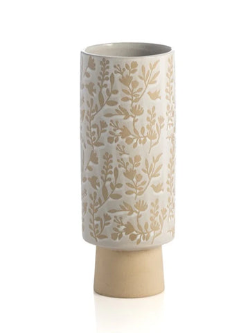 Tall white glaze cylinder vase with wax resist floral pattern on tan matte ceramic. Foot of vase inset from upper cylinder.