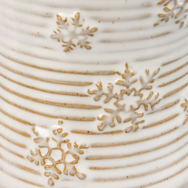 Detail View of EmbossedSnowflakeStonewareMug 10oz White glazed ceramic with embossed snowflake design in tan