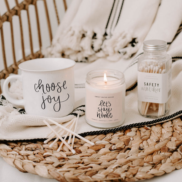 A fresh earthy mix of citrus, lavender and sage you'll enjoy during those cozy at-home date nights,. Cute script Let's Stay Home label on a clear glass jar with gold lid,